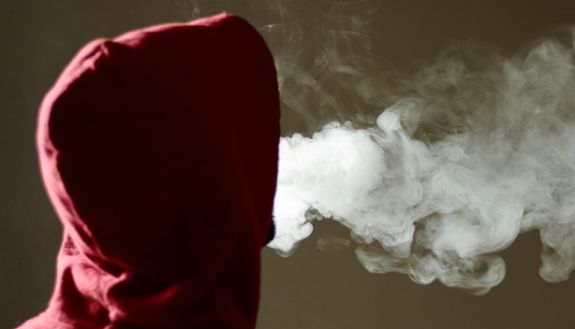 Hooded figure vaping