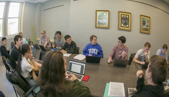 Students smiling and talking in a classroom