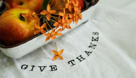 fall flowers and fruits on a white tablecloth.