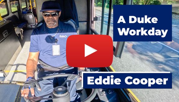 Eddie Cooper, bus driver for Duke Transit sits at his steering wheel.