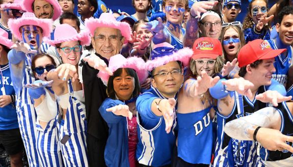 A collage of Duke faculty at a football game