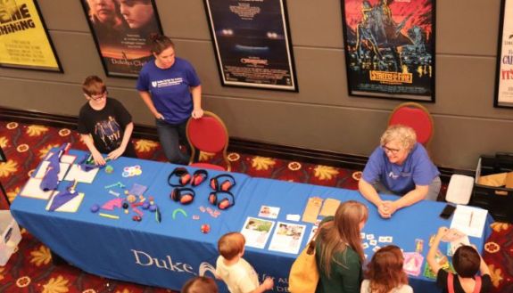 Birds Eye view of a table at the Carolina theater, with kids around it