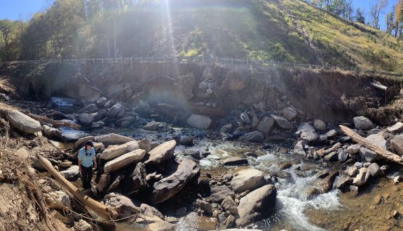 a big riverbed with rocks and a couple of children