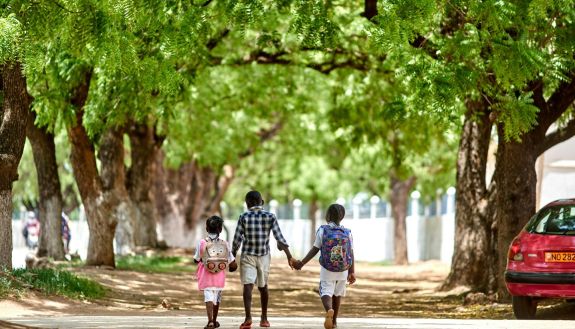 Children holding hands in a park