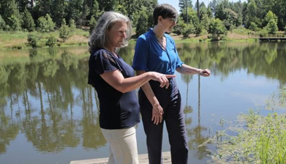 Two people looking out at Reclamation Pond