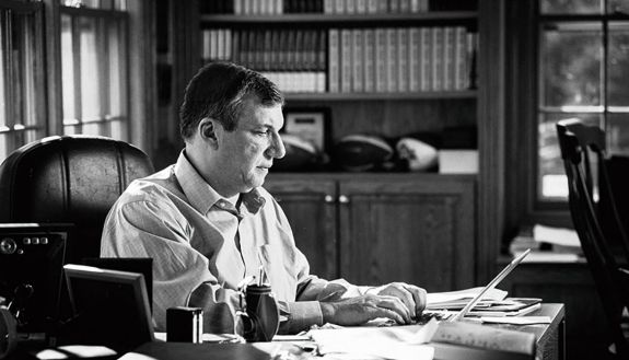 John Feinstein working at a computer
