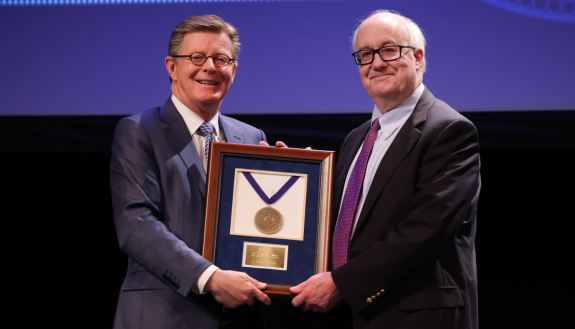 President Price presents Scott Gibson with leadership award. Photo by Huth Photo