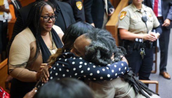 People hugging each other in court