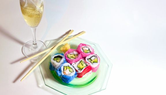 a photo of sushi pieces with plastic around each individual piece 