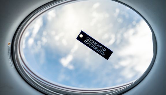 window looking out into space with a Duke sticker on the window