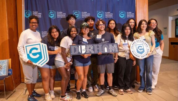 Group of students holding up a Durham sign