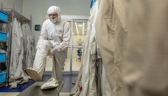 A man putting on a suit.