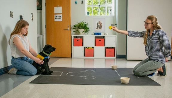 Two students training a puppy