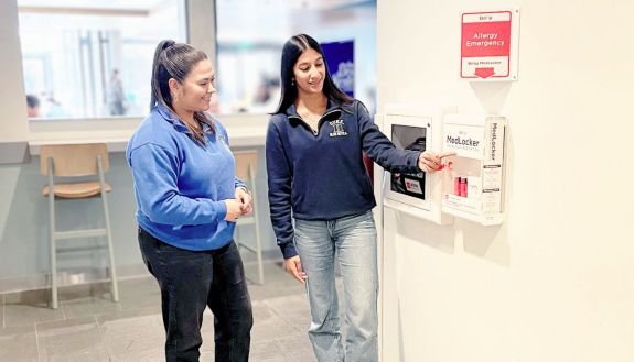 Two people by an allergy station