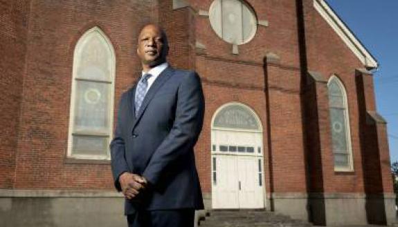 Quinton Dixie in front of Durham's historic St. Joseph's AME Church building.