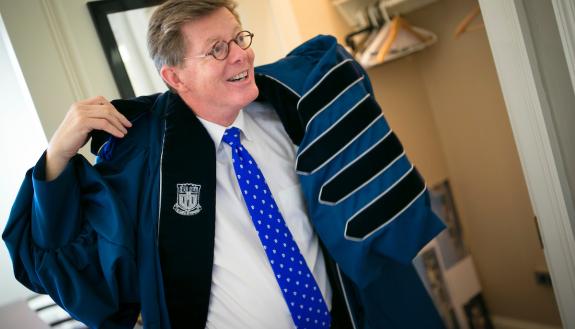 Vince Price gets his robe ready in advance of the inauguration. Photo by Duke Photography