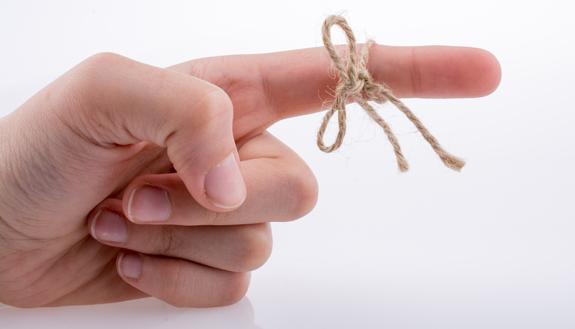 Image of finger with string.