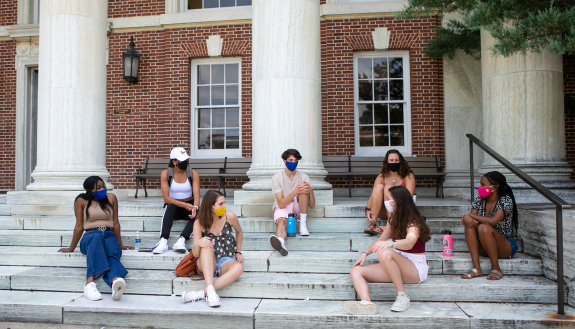 Residential students sit on the steps of East Union on East Campus. Student voices played a valuable role in reconfiguring campus housing for the pandemic.