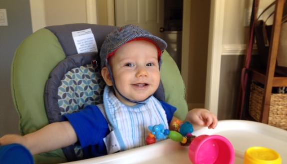 A baby wears a hat with a small video camera attached