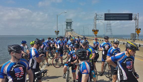 Riders in the Road to Hope stop on James River Bridge in Virginia.