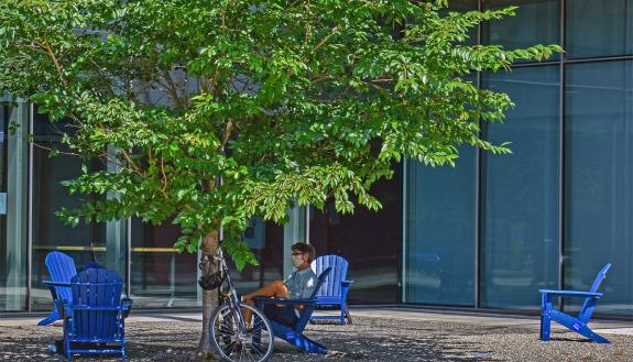 Someone enjoys one of Duke's new Adirondack chairs outside of the Rubenstein Arts Center. Photo by Mark Hough.