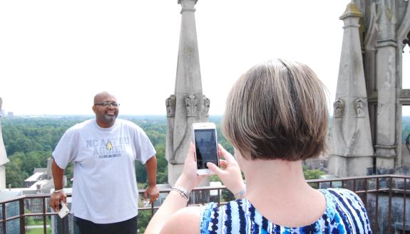 Carrie Slaughter takes a photo of co-worker Tracey McNeil atop Duke Chapel.