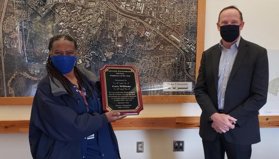 Housekeeping Specialist Cora Williams holds her Employee of the Year award alongside  Duke Vice President for Facilities John Noonan. Photo courtesy of Duke Facilities Management.