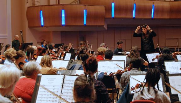 Verena Mösenbichler-Bryant, the Durham Medical Orchestra's conductor and artistic director, leads a rehearsal.