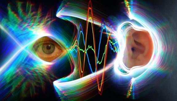 A photo of an ear a photo of an eye are separated by oscillating lines