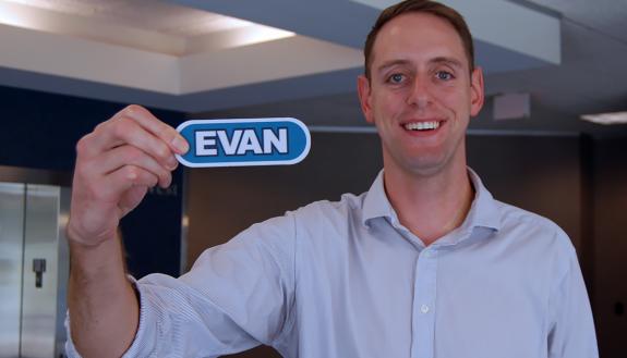PRMO Financial Analyst Evan Schroedel holds the name tag from his appearance on Wheel of Fortune.