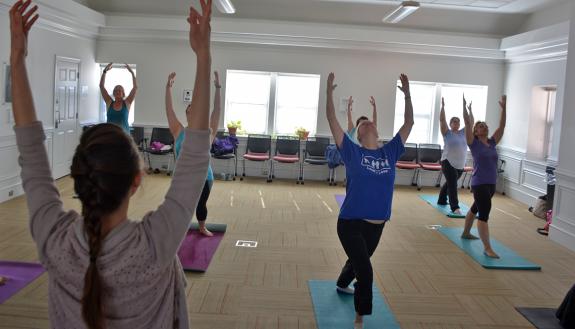 Employees at the John Hope Franklin Center attend a weekly yoga class.