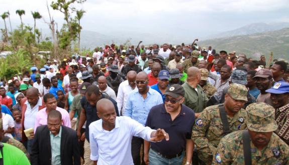  Haitian President Jovenel Moïse, in white shirt, and Prime Minister Jack Guy Lafontant, in baseball cap, visited Jérémie, promising houses for people left homeless by a hurricane on March 31, 2017.