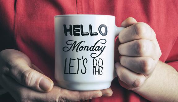 Hands holding a coffee mug.