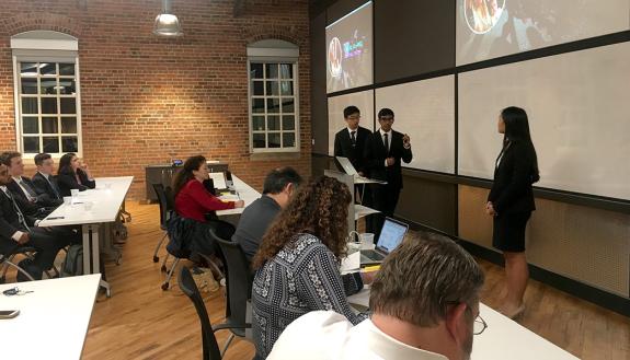 Jason Wang, Saheel Chodavadia and Sherry Feng present their app, Sawiana Enterprises, at the Hult Prize@Duke finals. Photo by Katherine Black