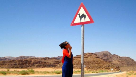 Maria Rameriz MPP'20 contemplates her future and a camel crossing sign in Jordan.