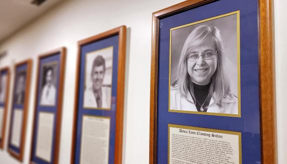 Debra Sudan's portrait, far right, hangs among the other Duke Surgery Master Surgeons. Photo courtesy of Duke Surgery.