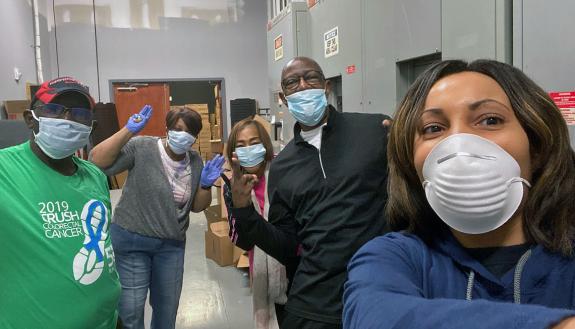 Monique Turrentine, far right, takes a selfie with volunteers who packed up boxes of non-perishable food to donate. Photo courtesy of Monique Turrentine.