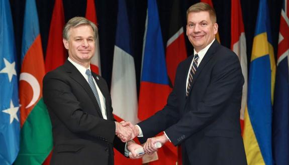 John Dailey, right, shakes hands with FBI Director Christopher Asher Wray at the National Academy graduation ceremony. Photo courtesy of John Dailey.