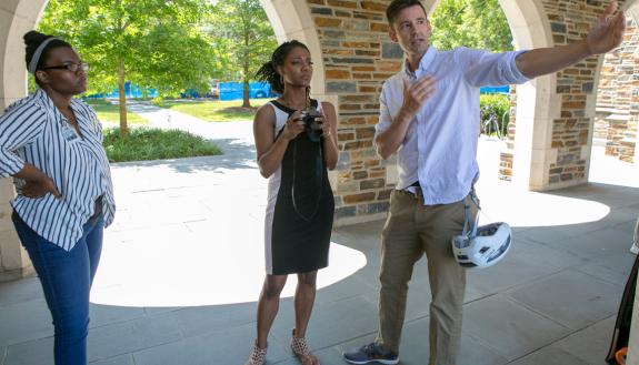 Shaun King, right, multimedia specialist with Political Science, teaches NCCU interns Deja Finch, left, and Cameron Rogers, center, during a photography workshop at the Brodhead Center. Photo by Jared Lazarus.