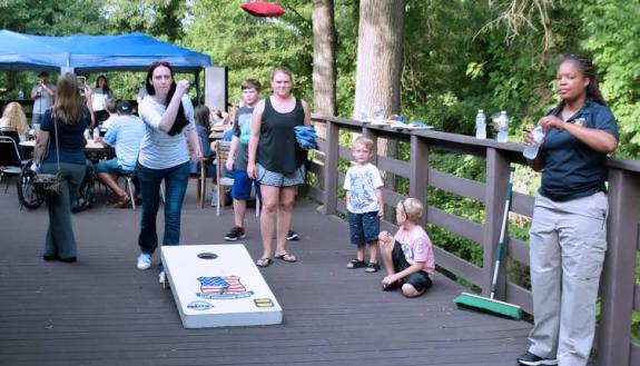 Ann Hale, a financial care counselor with Duke's Durham Gastroenterology Consultants and an alumna of Duke’s Citizens’ Police Academy, plays cornhole during last year's National Night Out event.