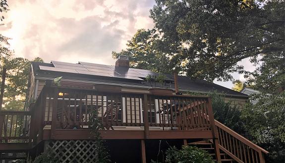 Solar panels atop Tam Huynh's home help keep her energy costs low.
