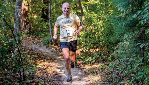 Mark Walters, running through the trees during the Rootrock Trail Run, will participate in the Boston Marathon next week. Photo courtesy of Mark Walters.  