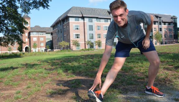Jonathan Black stretching before the first Duke Run/Walk Club session. Photo by Leanora Minai.