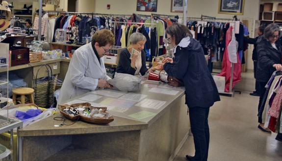 Katherine Halpern (left) and Ginny Lang (right) work the check out desk at the Nearly New Shoppe.