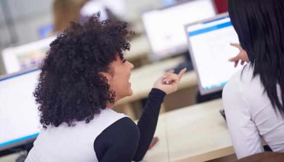 Two people at a computer.