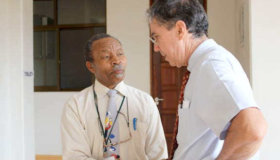 John Bartlett, DGHI associate director for research, talks with professor Noel Sam.