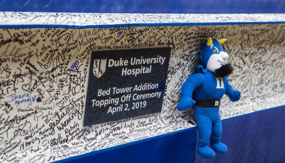 Duke Health team members added their signatures to the final beam at the top of the Bed Tower Addition. Photo by Shawn Rocco