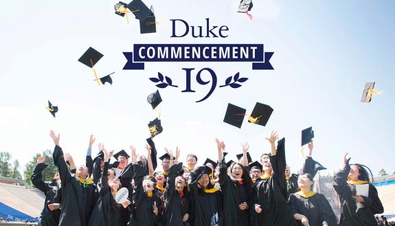 Duke students toss their mortarboards in the air in celebration of commencement