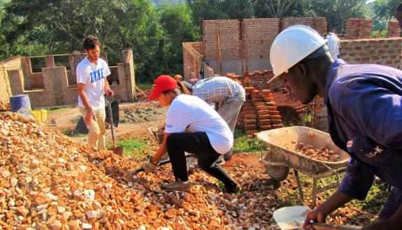 Students members of Duke Engineers for International Development (DEID) work on new school buildings in Uganda in 2015.