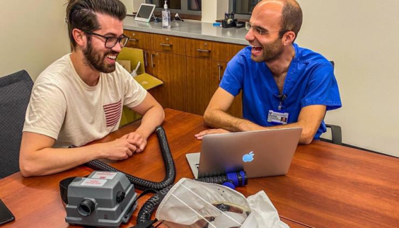 Design Health Fellows Alejandro Pino (left) and Konstantinos Economopoulos (right) collaborating on a presentation for the PAPR Bridge Project. Picture taken by Theresa Thompson